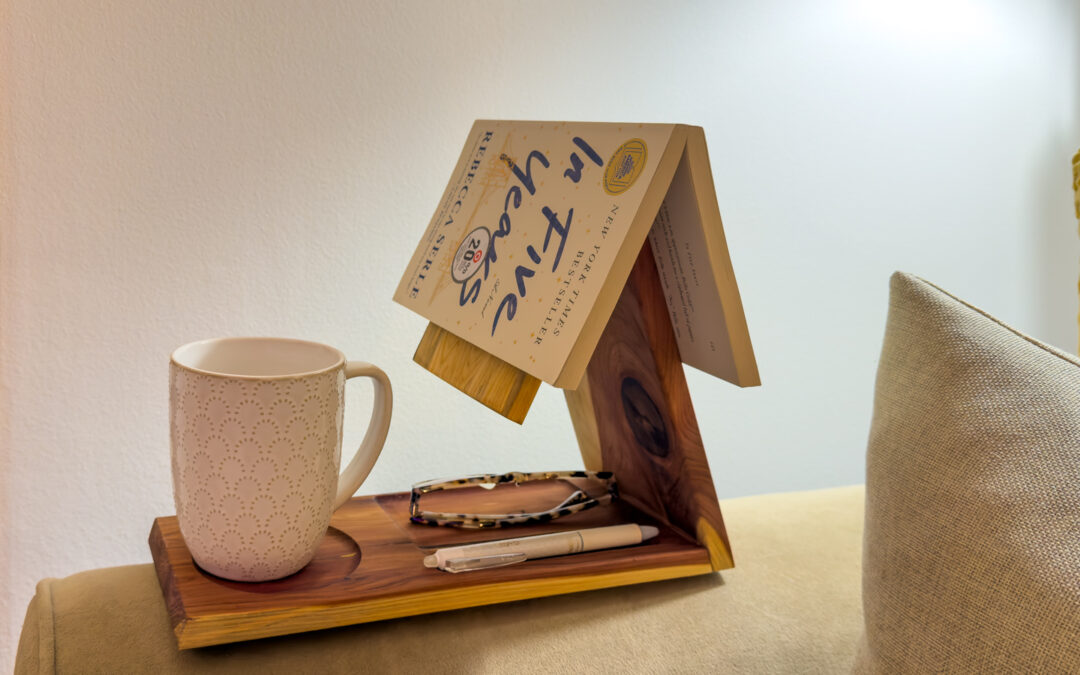 Cedar book, coffee, glasses, and pen holder in a reading nook