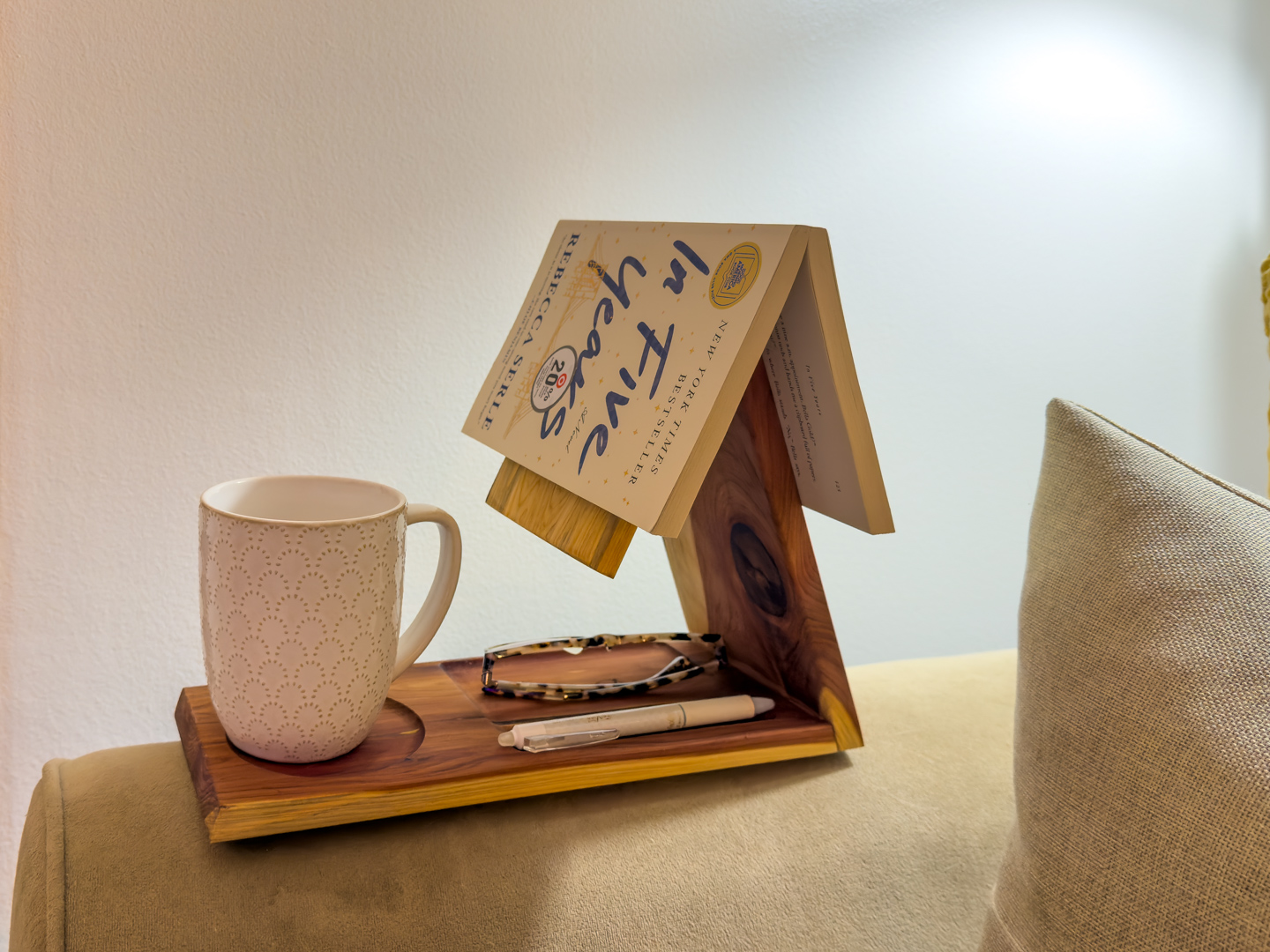 Cozy reading nook with mug and book tray