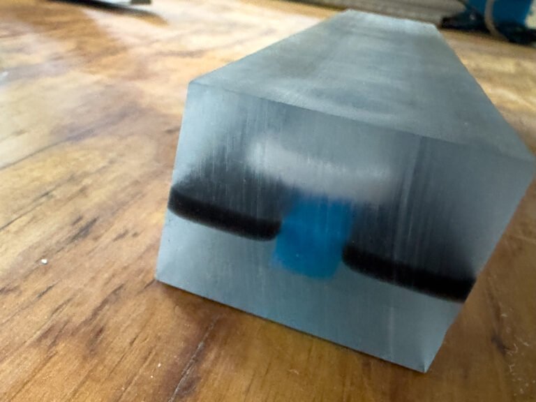 Epoxy block with a dark accent band during construction of a personalized epoxy desk nameplate coin display