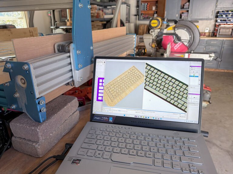 Computer design for a carved wooden keyboard tribute plaque beside the workshop router