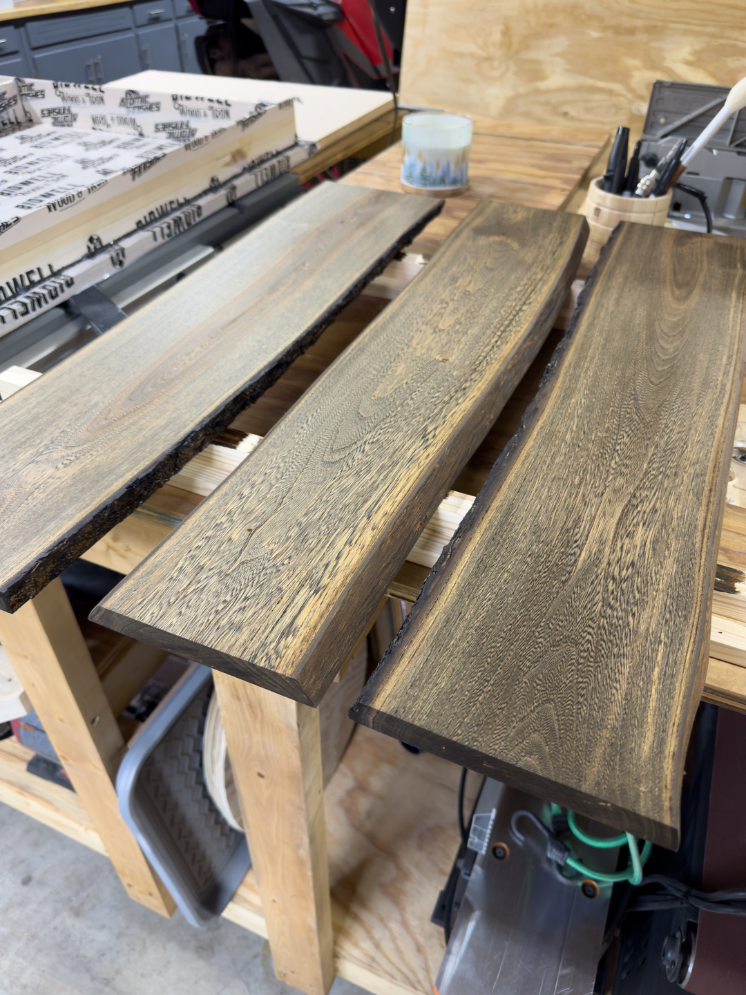 Wood slabs laid out on a workbench, ready for finishing