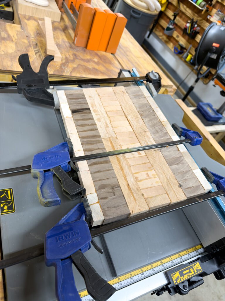 Clamped hardwood strips during construction of a custom end grain cutting board