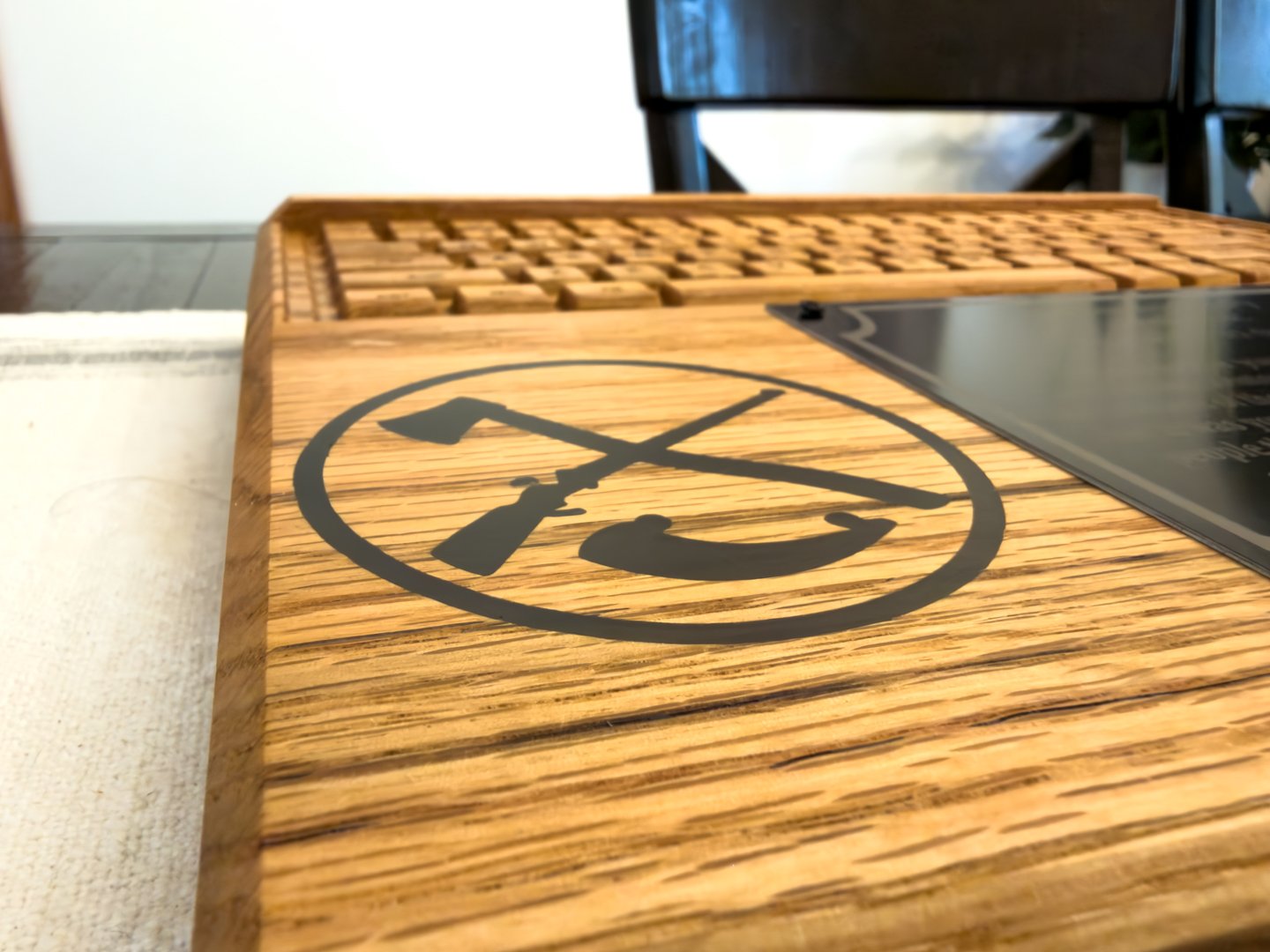 Close-up of a wooden table with a crossed-tools symbol