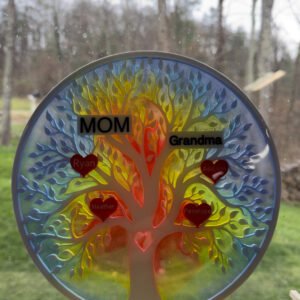 Colorful family tree suncatcher set on a windowsill with rainbow resin glowing in the light