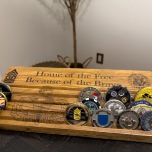Engraved challenge coin display rack with artwork across the rows between the coins