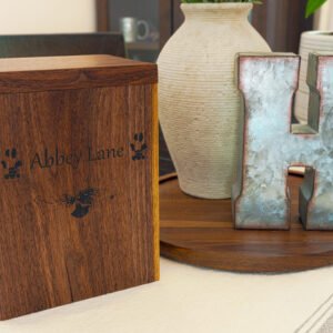 Personalized walnut pet memorial box engraved with a dog’s name and paw prints