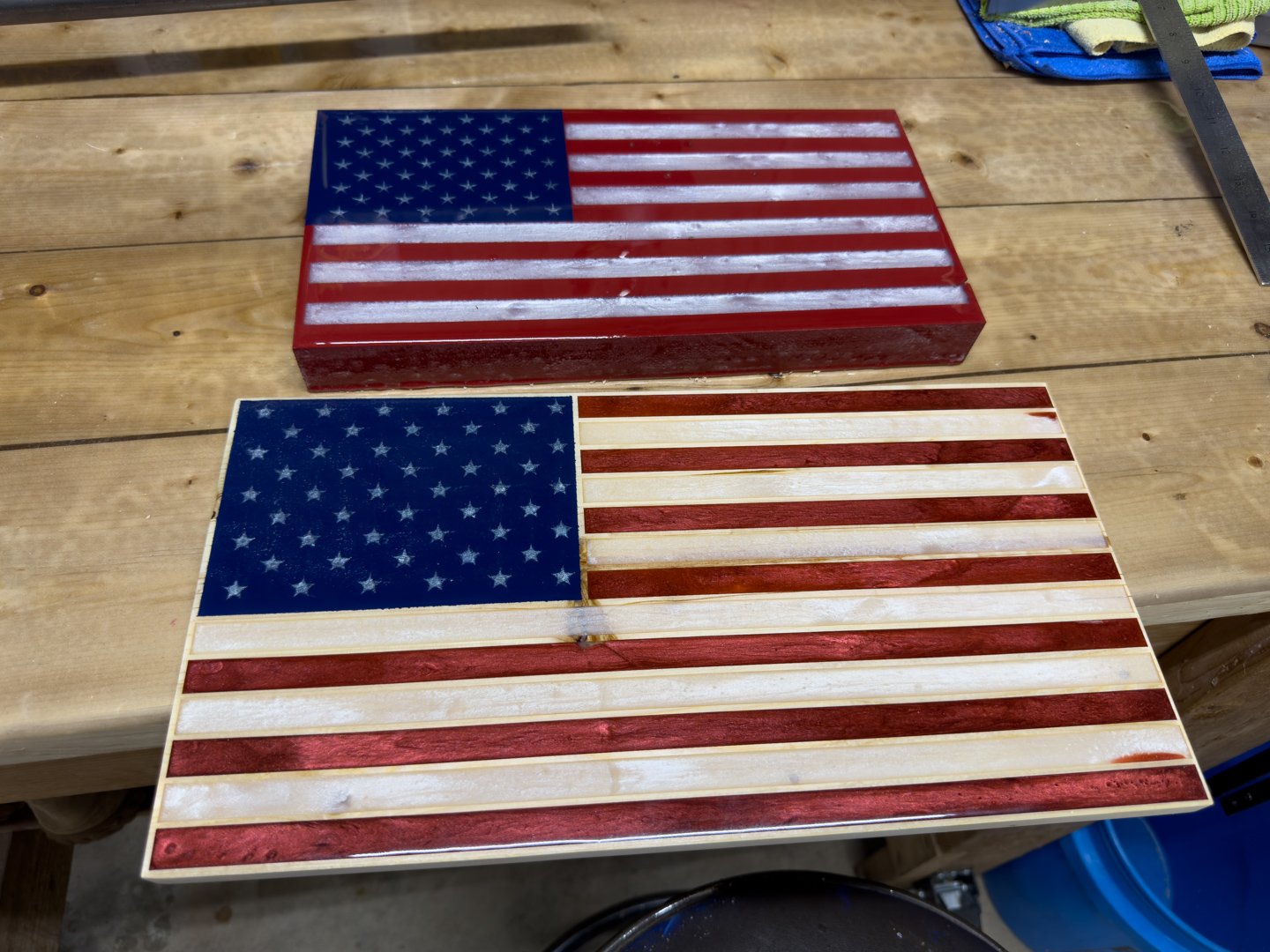 Handcrafted wooden American flag wall art panel leaning on a surface, red and white stripes with a blue star field