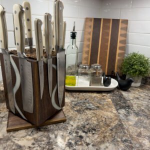 A walnut knife block with flowing white epoxy rivers and a set of knives held by hidden magnets, on a granite countertop