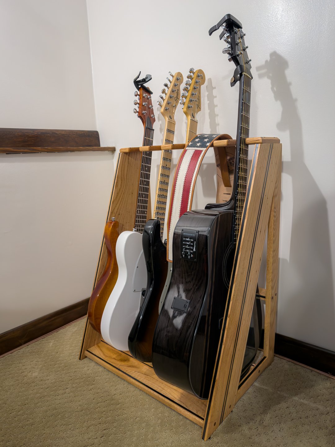 Handmade multi guitar display rack holding acoustic and electric guitars upright