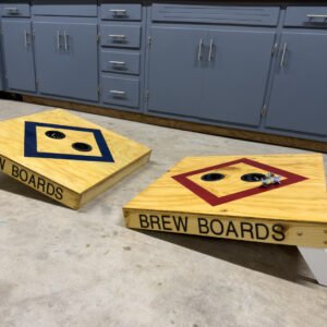 A pair of custom toss game boards in navy and red with a painted diamond target and lettered side rails