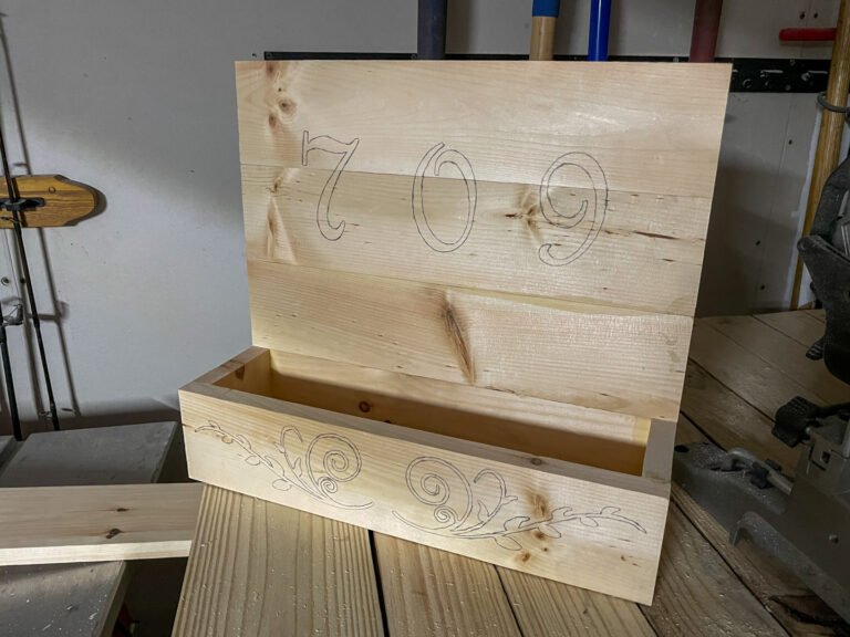 Unfinished house number planter box with carved numbers and family-name lettering
